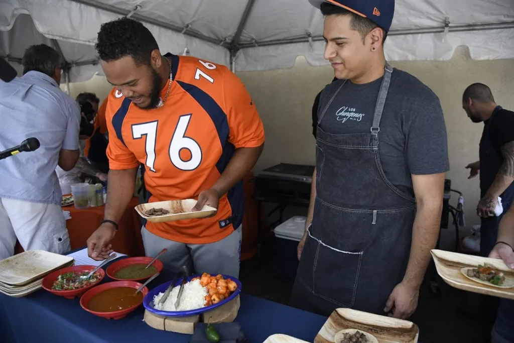 broncos John Leyba, The Denver Post Denver Broncos players Max Garcia makes up his own little taco as chef Juan Coronado of Los Chignons looks on during a Taste of the Broncos in 2016.